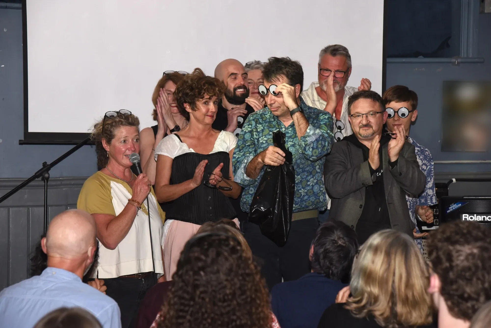 Le Cluck graduates celebrating together on stage after their charity show